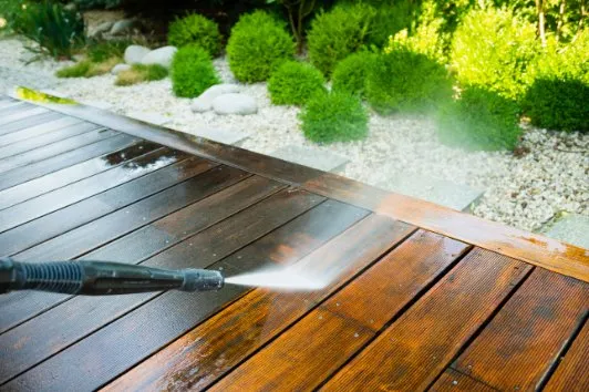Professional pressure cleaner pressure washing a deck in Melton VIC.